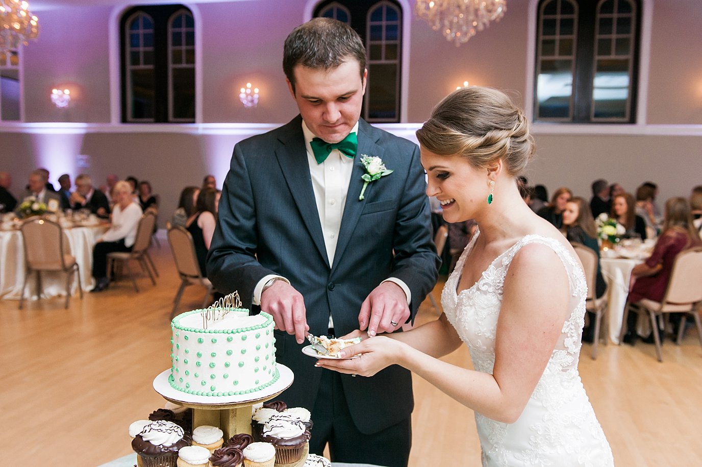 bride and groom cut cake