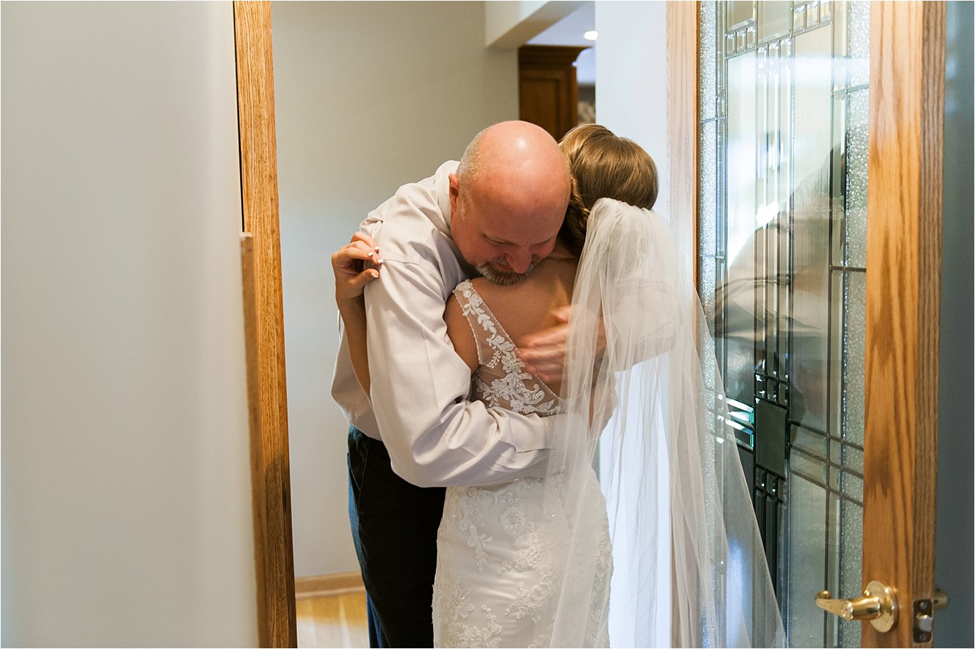 father hugs bride