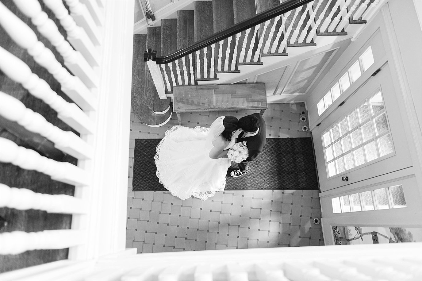 bride and groom framed by staircase
