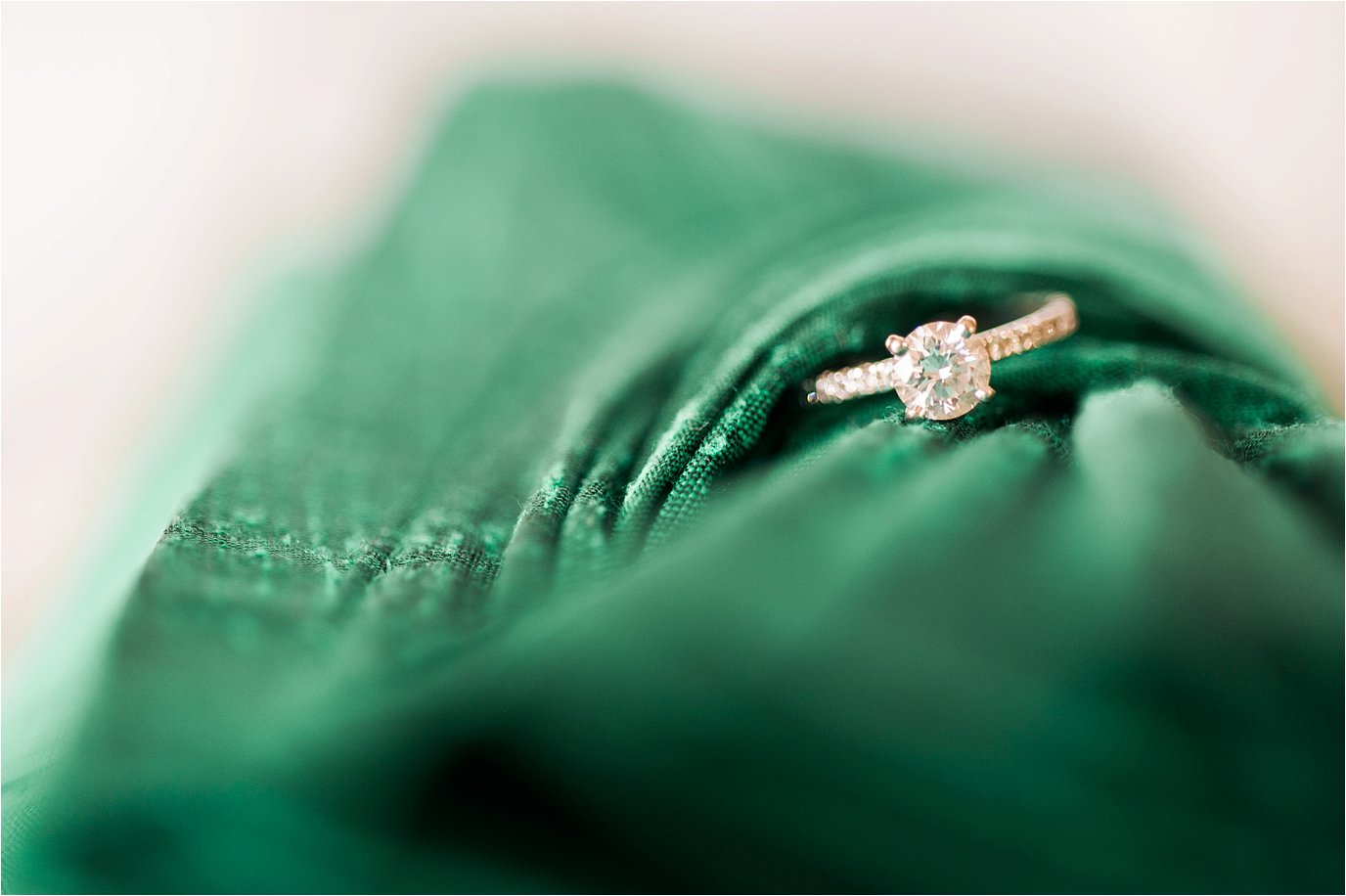green purse and engagement ring