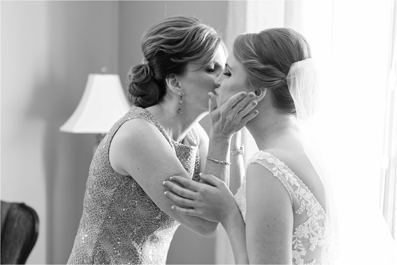 mother kisses bride